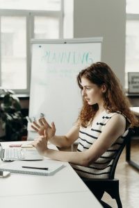A woman sitting in an office planning a business relocation